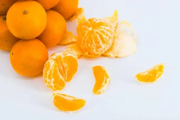 A delightful composition capturing the freshness of mandarins against a clean white backdrop.