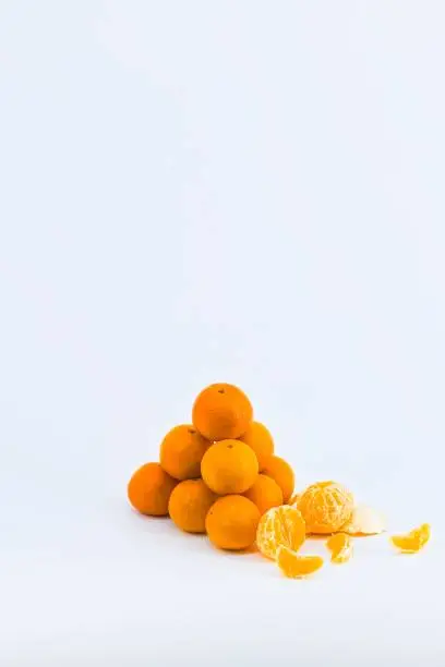 A delightful composition capturing the freshness of mandarins against a clean white backdrop.