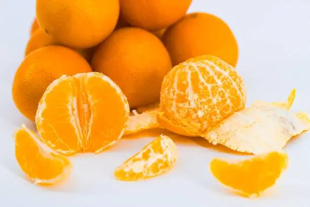 A delightful composition capturing the freshness of mandarins against a clean white backdrop.