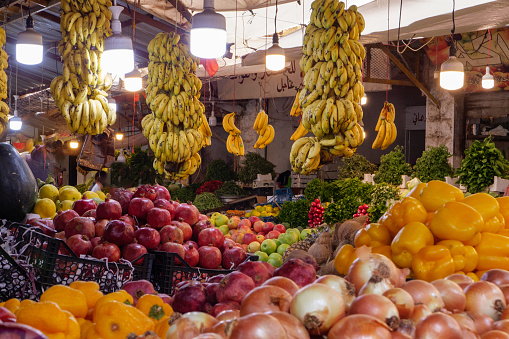 Bartlett/ Williams pear, green grapes, banana, red and yellow apples, oranges/ tangerine fruits on display at local farmers market. Fresh ripe raw organic colorful fruit on sale at marketplace store.