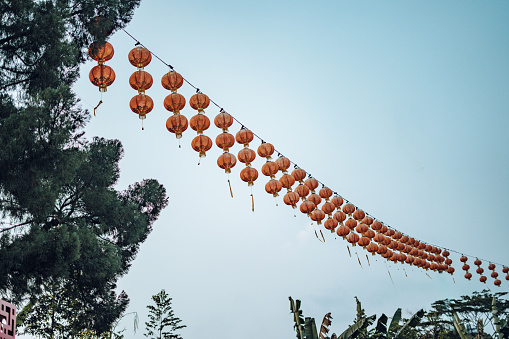 Abundance of lanterns hanging in Thean Hou Temple in Kuala Lumpur, Malaysia. With skyline in the background.