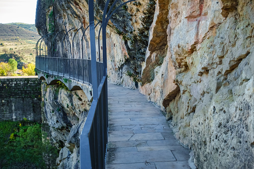 Path that runs hanging from the vertical rock wall at the Ponton de la Oliva, Madrid