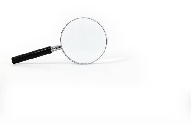 istock A photo featuring a magnifying glass with a black handle and a silver rim around the magnifying glass, captured against a white background. 1813512560