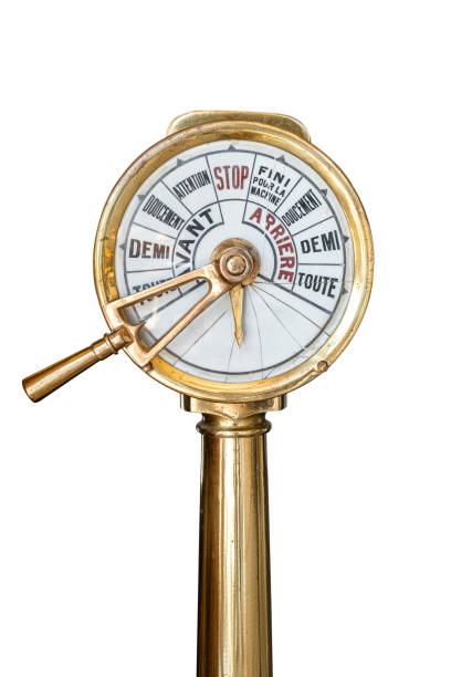 An old-fashioned barometer mounted in a decorative wooden ship wheel frame. A classic maritime weather instrument with nautical design.