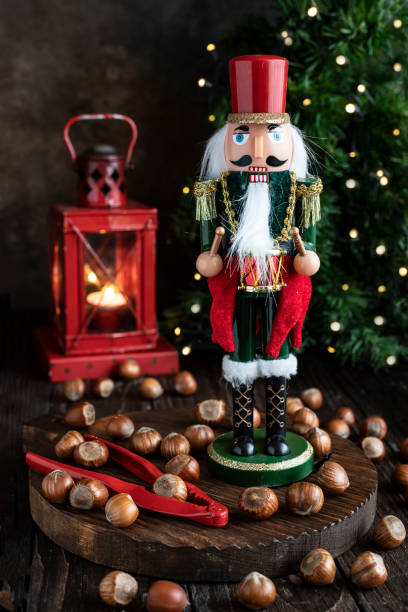 istock Festive Nutcracker soldier on Christmas background with hazelnuts 1813530518