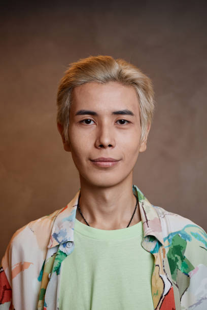 nahaufnahme junger asiatischer mann mit blondierten haaren im studio - lightener stock-fotos und bilder