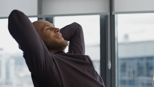 istock Relaxed creator taking break at office closeup. Man putting hands behind head 1813580100