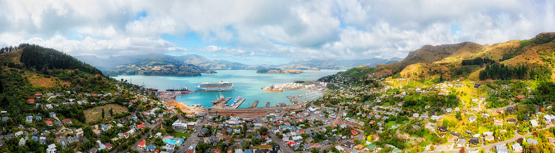 Lyttleton port town near Christchurch city in New Zealand on Pacific coast with cruise liner docked in habour.