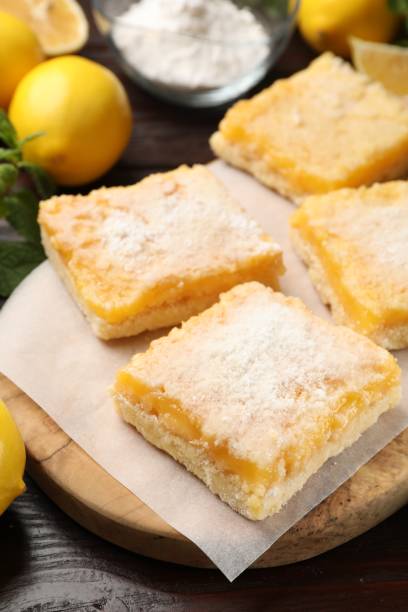 istock Tasty lemon bars with powdered sugar on table, closeup 1813638794