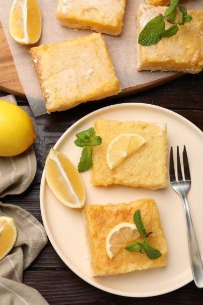 istock Tasty lemon bars served on wooden table, flat lay 1813641045