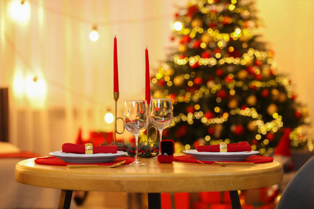 istock Making proposal. Christmas table setting with candles and engagement ring indoors 1813650766