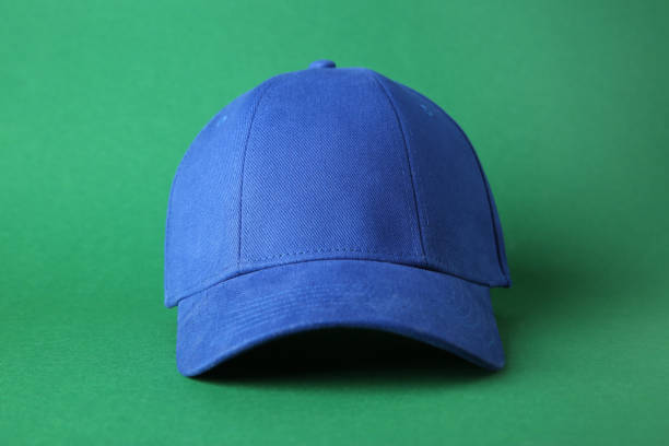 istock Stylish blue baseball cap on green background 1813652371