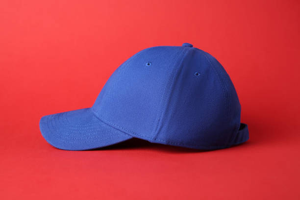 istock Stylish blue baseball cap on red background 1813652391