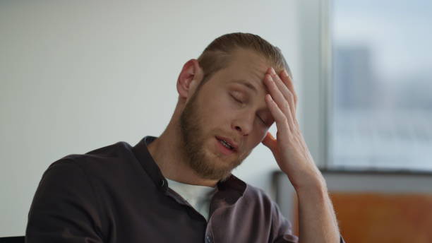 istock Overworked programmer massaging head office closeup. Man suffering from migraine 1813731523