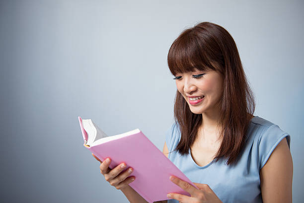 istock Asian woman reading a book 181376665