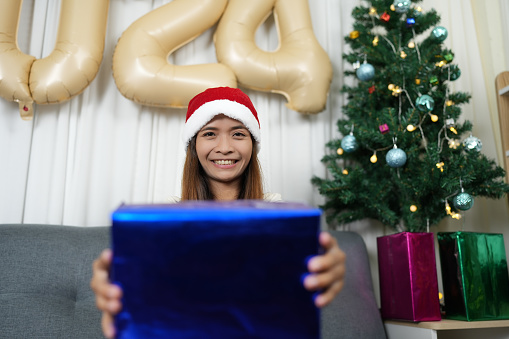 Merry Christmas 2024 concept Asian women are happy to receive gifts on Christmas Day.