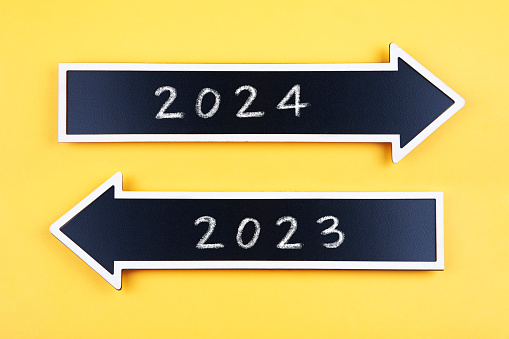 Arrows wit 2023 and 2024 on yellow background