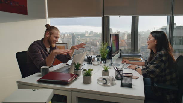 Professional and a client talking in a modern office setting.