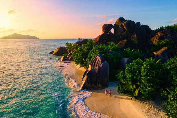 istock Anse Source d'Argent beach, La Digue Island, Seyshelles, Drone aerial view of La Digue Seychelles bird eye view, couple men and woman walking at the beach during sunset at a luxury vacation 1813842341