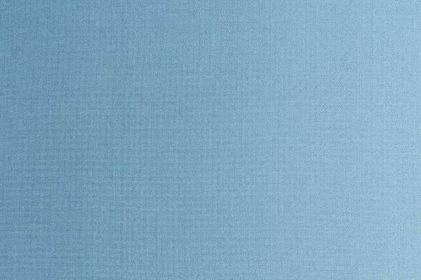 istock Silk authentic natural fabric wallpaper texture background in dark shiny blue jean grey color tone 1813854669