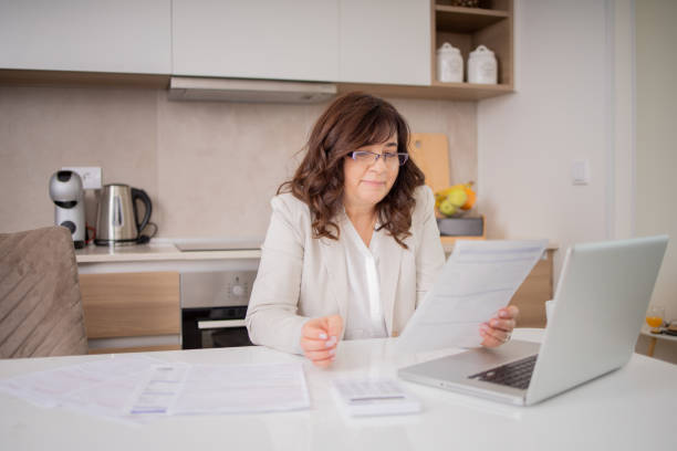 istock Mature woman going through paperwork 1813855530