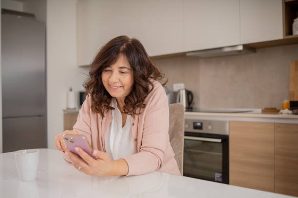 istock Happy mature woman using phone 1813856985