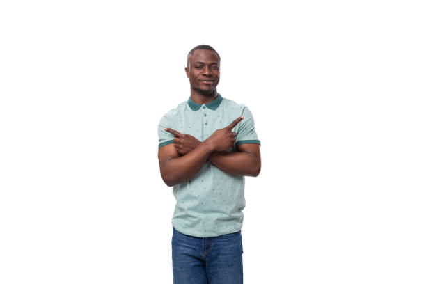 istock young handsome short-haired american man dressed in a summer t-shirt points his hands in different directions 1813860863