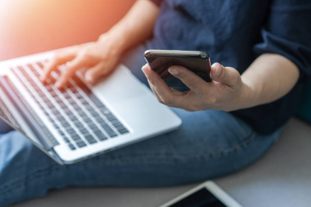 istock Digital lifestyle blog writer or business person work at home using smart device working on mobile smartphone and computer laptop via internet communication network technology and e-commerce marketing 1813861341