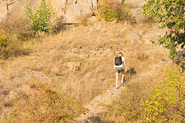 Solitary man hiking on a mountain path