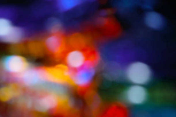 istock A fun-looking, developed image with lots of colorful blurred illumination halos on a dark background. 1813889447