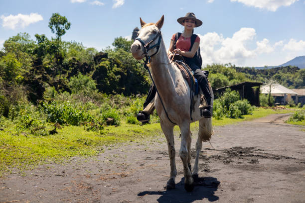 istock Young woman riding a white horse 1813897663