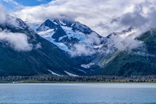 Moody clouds float over the Byron Glacier above Portage Lake in Chugach National Forest, Alaska.