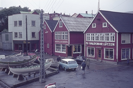 Thorshavn, Streymoy, Faroe Islands, 1964. Street scene with locals, wooden houses, boats and shops in Torshavn, Faroe Islands.