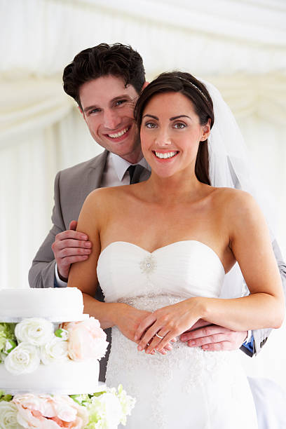 istock Bride And Groom With Wedding Cake At Reception 181397807