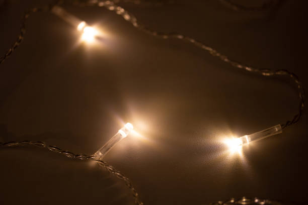 istock Festive warm yellow garland lights on the surface 1813988689