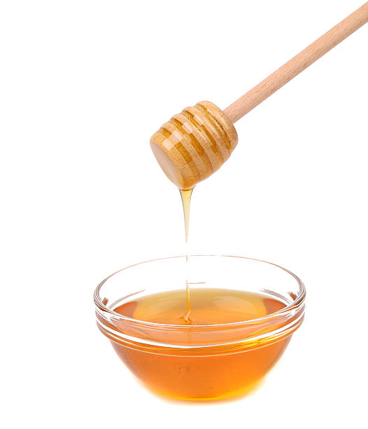 istock Honey dripping from a wooden dipper. 181401352