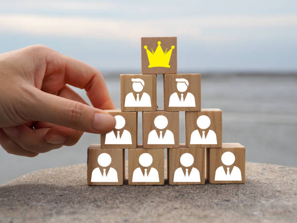 istock Man icon with crown on wooden block 1814022628