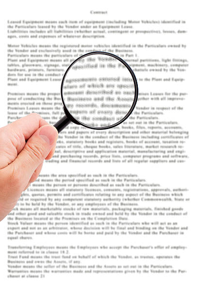 Hand holding magnifying glass reading document Hand holding magnifying glass reading important  document read the fine print stock pictures, royalty-free photos & images