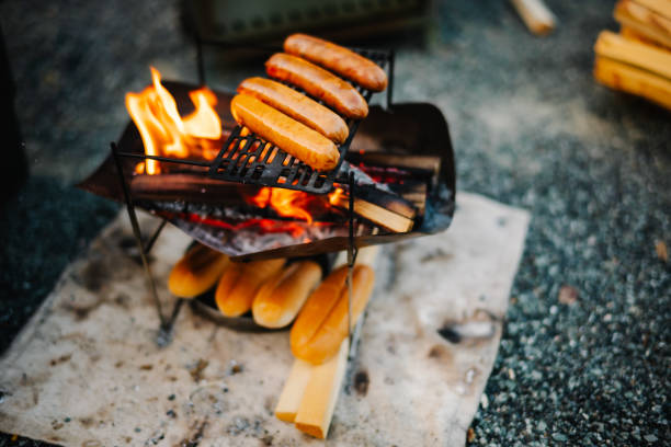 Cooking hot dogs at camp.