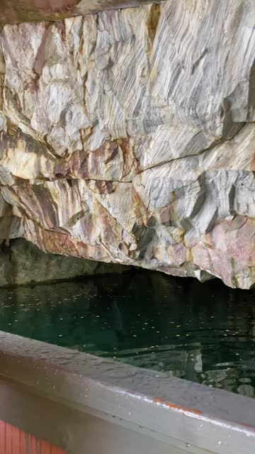 Cave in rock of mountain lake.
