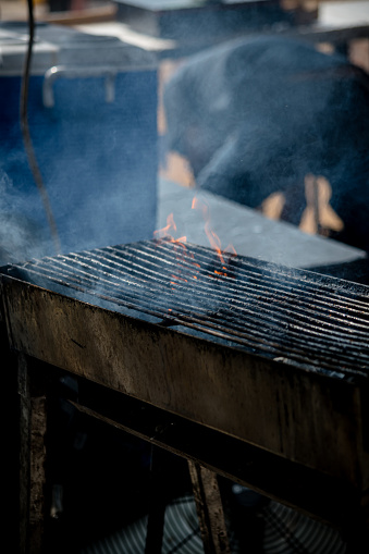 a festival grill that wears the marks of a day's culinary symphony. Up close, witness the heat-kissed, battle-scarred surface, telling tales of flavors imparted and moments shared in the vibrant tapestry of street food festivities.
