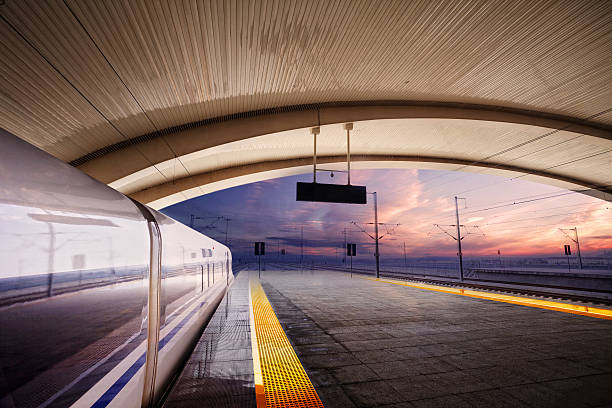 istock train stop at railway station with sunset 181412074