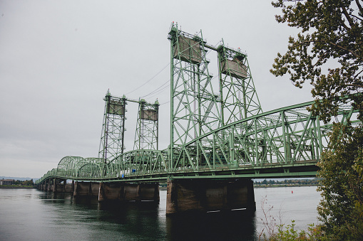 The Interstate 5 bridge between Portland Oregon and Vancouver Washington. Land vehicles travel across the Columbia river either North or South bound between Portland Oregon and Vancouver Washington.