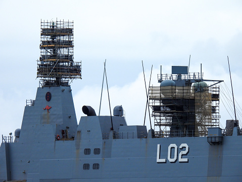 Moored modern supply and tanker warship Jacques Chevallier A-725 at French Navy Naval Base at City of Toulon on a cloudy late spring day. Photo taken June 9th, 2023, Toulon, France.