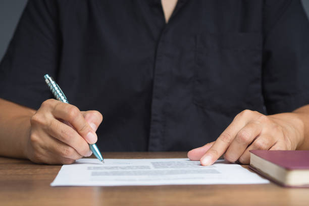 istock Businessman signing a contract or agreement while sitting at the table in the office 1814169647