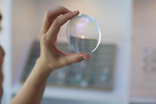 istock Hand holding glasses lens, lens glasses in hand 1814185904