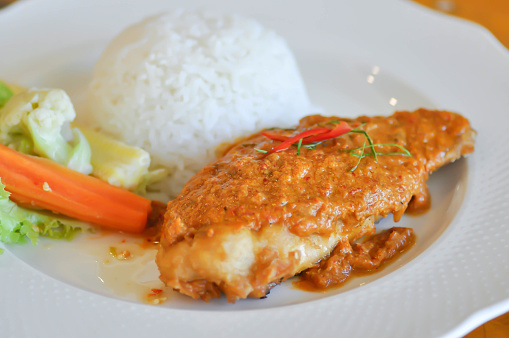 stir fried fish with chili ,sauce and rice or a king of curry cooked with fried fish served with a spicy sauce or Thai food
