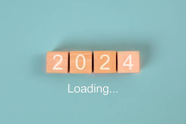 istock 2024 new year loading concept. 2024 word with wooden blocks on blue background 1814208515