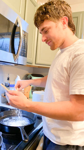 istock Man Uses Device to Assist in Preparing Food 1814213256