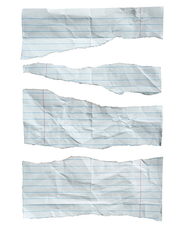 Torn lined notebook paper on white background with clipping path